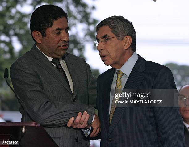 Milton Jimenez of the delegation representing ousted Honduran President Manuel Zelaya shakes hands with Costa Rican President Oscar Arias after talks...