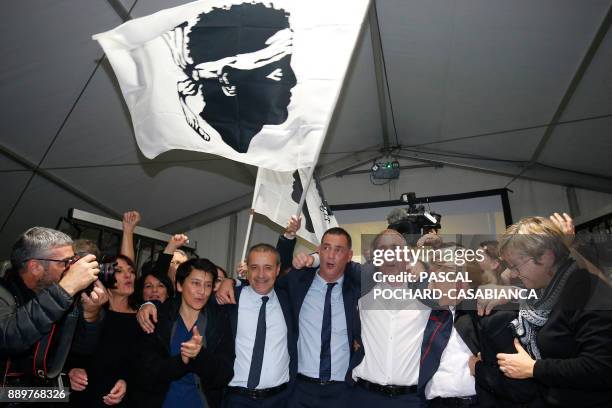 Candidates for the Pe a Corsica nationalist party Jean Guy Talamoni and Gilles Simeoni celebrate with supporters after the annoucement of the results...
