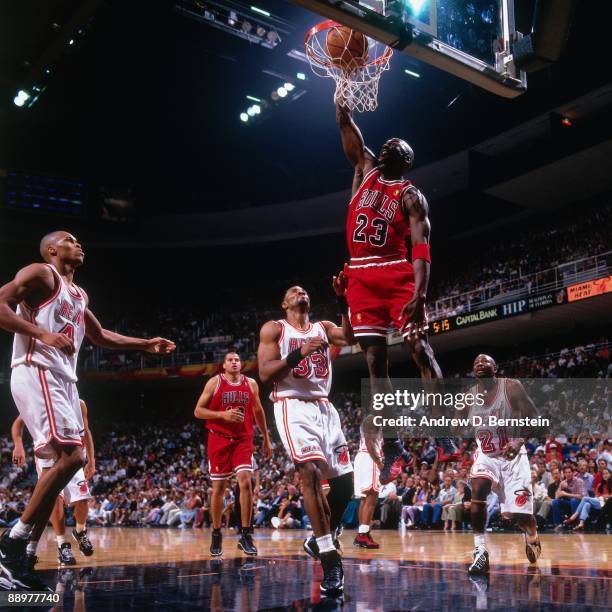 Michael Jordan of the Chicago Bulls dunks against Alonzo Mourning of the Miami Heat in Game Three of the Eastern Conference Finals during the 1997...