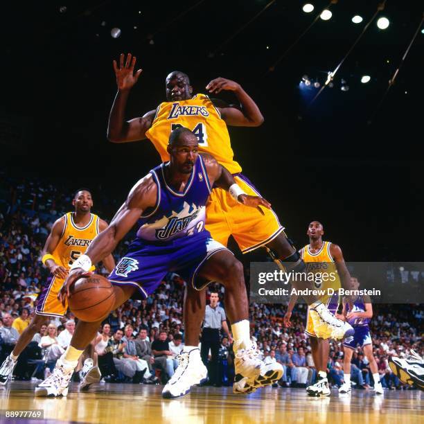 Karl Malone of the Utah Jazz makes a move to the basket against Shaquille O'Neal of the Los Angeles Lakers in Game Four of the Western Conference...