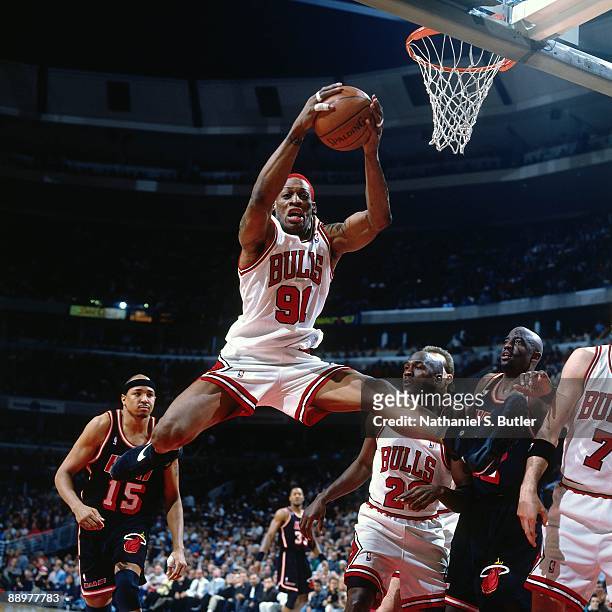 Dennis Rodman of the Chicago Bulls rebounds against the Miami Heat in Game One of the Eastern Conference Quarterfinals during the 1996 NBA Playoffs...