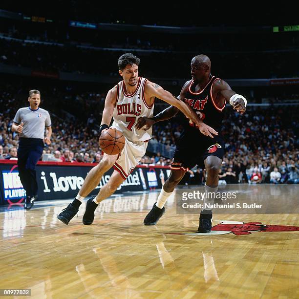 Toni Kukoc of the Chicago Bulls drives to the basket against Walt Williams of the Miami Heat in Game One of the Eastern Conference Quarterfinals...