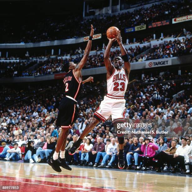 Michael Jordan of the Chicago Bulls shoots a jump shot against Keith Askins of the Miami Heat in Game One of the Eastern Conference Quarterfinals...