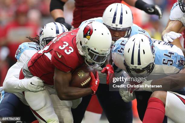 Kerwynn Williams of the Arizona Cardinals carries the football against the Tennessee Titans defense in the first half of the NFL game at University...