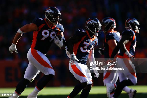 Defensive end Adam Gotsis of the Denver Broncos celebrates recovering a fumble with Will Parks during the first quarter against the New York Jets at...