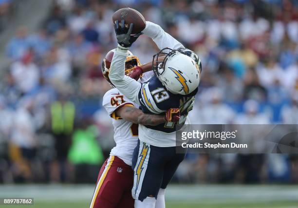 Wide receiver Keenan Allen of the Los Angeles Chargers makes a catch in the second quarter over cornerback Quinton Dunbar of the Washington Redskins...