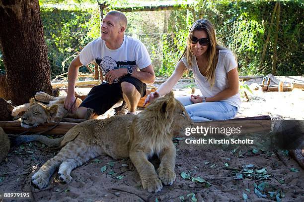 Mick and Karissa Fanning pet the ten month old lion cubs at the Seaview Lion Park outside Port Elizabeth on July 11, 2009 in South Africa.