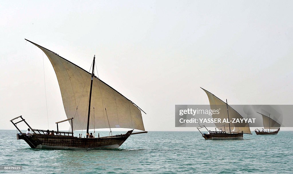 Kuwaitis sail in traditional dhows off K