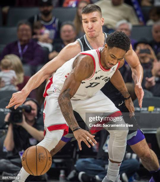 Sacramento Kings guard Bogdan Bogdanovic defends Toronto Raptors guard DeMar DeRozan on Sunday, Dec. 10, 2017 at the Golden 1 Center in Sacramento,...