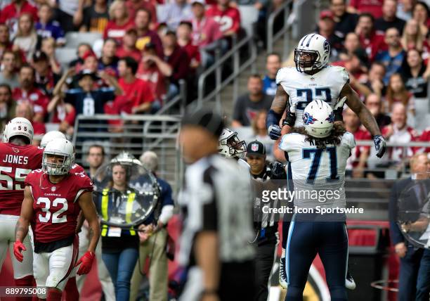 Tennessee Titans offensive tackle Dennis Kelly hoists up running back Derrick Henry after a touchdown during the NFL football game between the...
