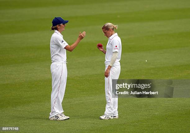 Charlotte Edwards sets a field as Laura Marsh of England prepares to bowl during The 2nd Day of The 1st Test between England Women and Australia...