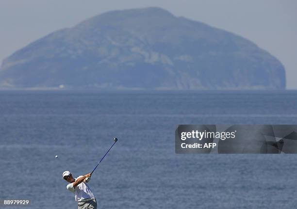 Sweden's Henrik Stenson tees off of the 9th tee box with the island of Ailsa Craig in the background on the Ailsa Course in Turnberry, Scotland, on...