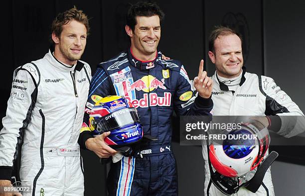 Red Bull's Australian driver Mark Webber poses withBrawn GP's Brazilian driver Rubens Barrichello and Brawn GP's British driver Jenson Button in the...