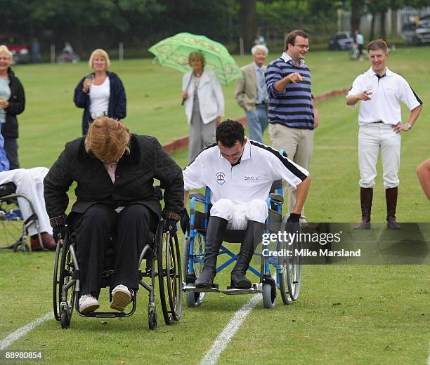 Jockey Liam Treadwell takes part in a wheel chair race at the Rundle Cup at Tidworth Polo Club on July 11, 2009 in Wiltshire, England.