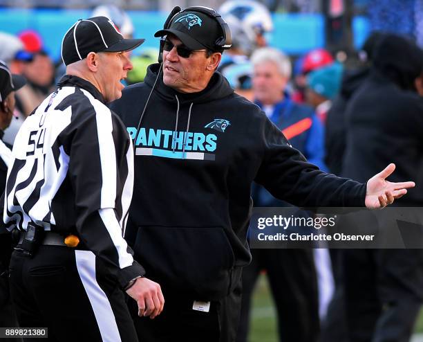 Carolina Panthers head coach Ron Rivera, right, talks with umpire Steve Woods, left, during second quarter action against the Minnesota Vikings on...