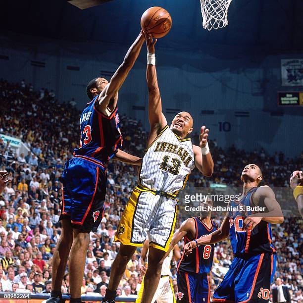 Mark Jackson of the Indiana Pacers shoots a layup against Marcus Camby of the New York Knicks in Game Five of the Eastern Conference Finals during...