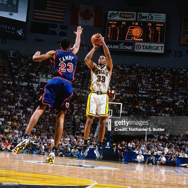 Antonio Davis of the Indiana Pacers shoots a jump shot against Marcus Camby of the New York Knicks in Game Five of the Eastern Conference Finals...