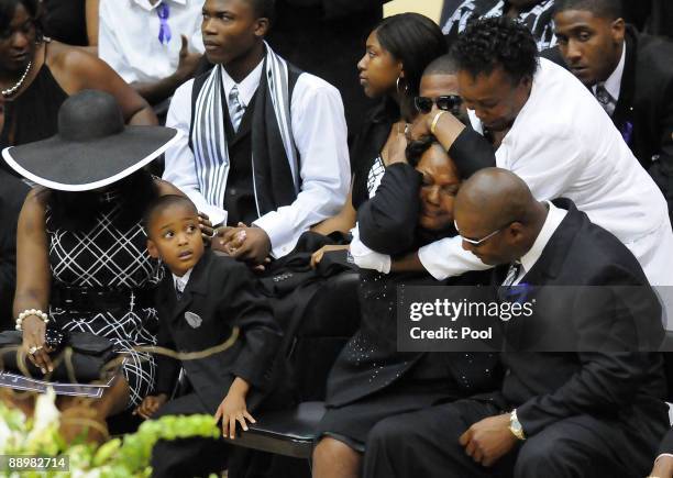 Former NFL quarterback Steve McNair's mother Lucille McNair is consoled at the end of a funeral service for her son on July 11, 2009 in Hattiesburg,...