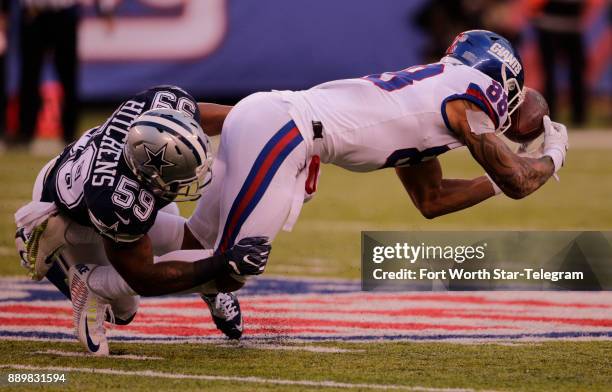 Dallas Cowboys linebacker Anthony Hitchens separates New York Giants tight end Evan Engram from a pass in the second half on Sunday, Dec. 10, 2017 at...