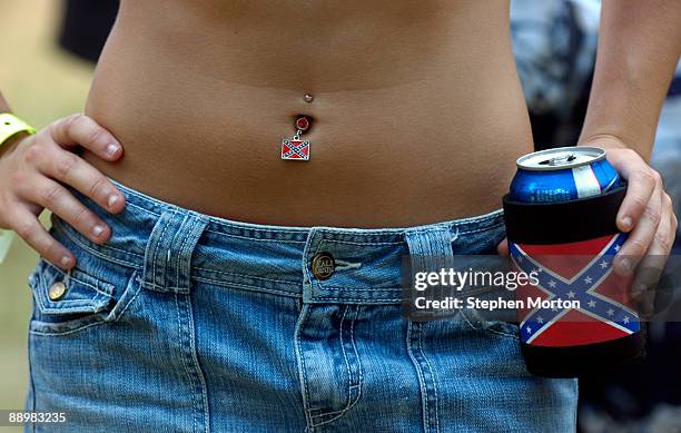 Megan Lever shows off her Confederate flag belly-button ring and beer cooler during the 13th Annual Summer Redneck Games July 11, 2009 in East...