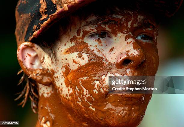 Kersey of Eatonton, Georgia looks for friends after the Mud Pit Bellyflop contest during the 13th Annual Summer Redneck Games July 11, 2009 in East...