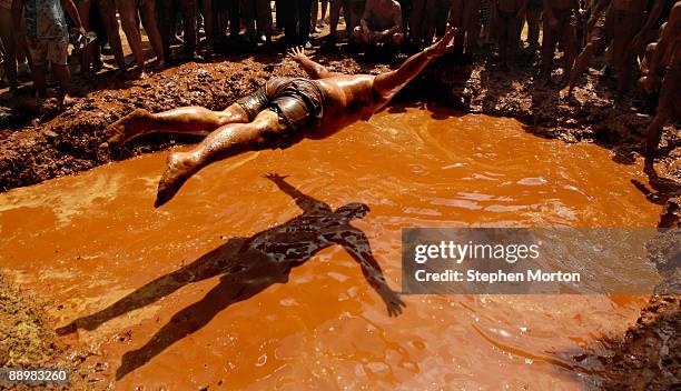 Ed Molina, last years winner of the Mud Pit Bellyflop contest, tries his best to repeat in the event during the 13th Annual Summer Redneck Games July...