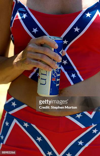 Decked out in her favorite Confederate Flag bathing suit a woman holds a beer during the 13th Annual Summer Redneck Games July 11, 2009 in East...