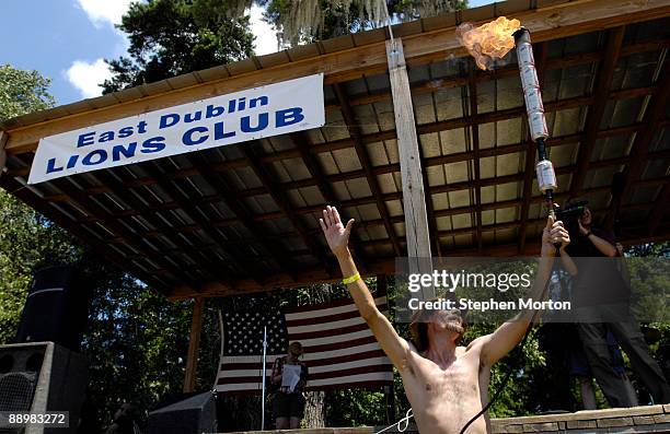 Mascot Preston Wright lights the ceremonial torch to kick off the 13th Annual Summer Redneck Games July 11, 2009 in East Dublin, Georgia. Started in...