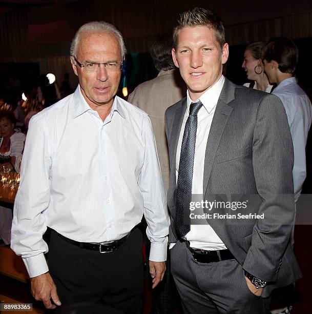 Franz Beckenbauer and Bastian Schweinsteiger attend a party after 'Kaiser Cup 2009' golf tournament at the Hartl Resort Event Hall on July 11, 2009...