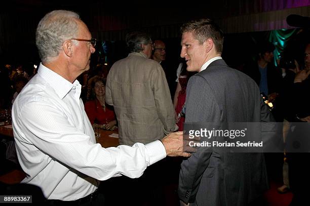 Franz Beckenbauer and Bastian Schweinsteiger attend a party after 'Kaiser Cup 2009' golf tournament at the Hartl Resort Event Hall on July 11, 2009...