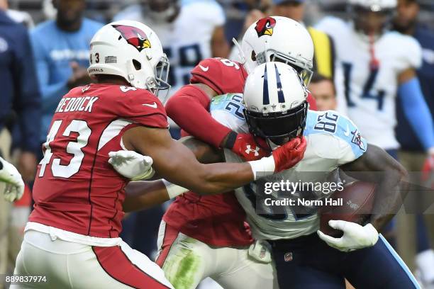 Delanie Walker of the Tennessee Titans runs with the football against Haason Reddick and Brandon Williams of the Arizona Cardinals in the second half...