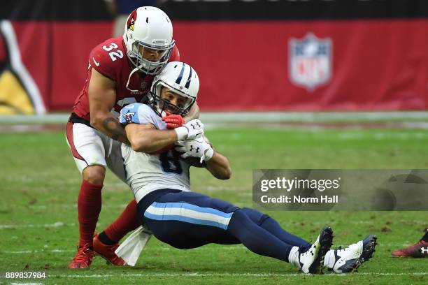 Eric Decker of the Tennessee Titans is tackled by Tyrann Mathieu of the Arizona Cardinals in the second half at University of Phoenix Stadium on...