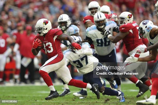 Kerwynn Williams of the Arizona Cardinals rushes the footbball in front of Johnathan Cyprien of the Tennessee Titans in the second half at University...