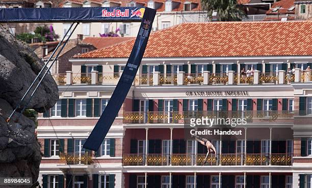 In this handout image provided by Dean Treml/Red Bull Photofiles, Artem Silchenko of Russia dives from the 26 meter platform during round three of...
