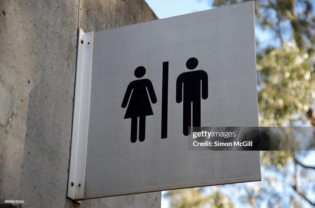 Female and male toilet sign on the exterior of a public restroom block