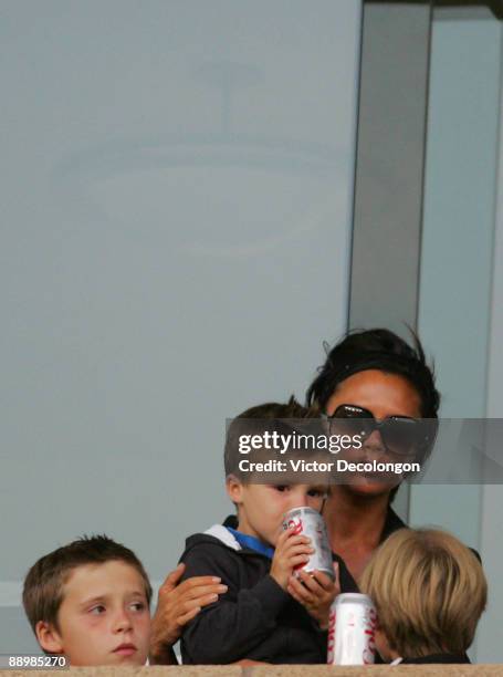 Victoria Beckham holds her son Cruz during the MLS match between the Los Angeles Galaxy and Civas USA at The Home Depot Center on July 11, 2009 in...