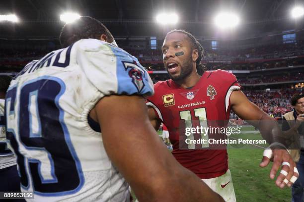 Wide receiver Larry Fitzgerald of the Arizona Cardinals greets inside linebacker Wesley Woodyard of the Tennessee Titans following the NFL game at...