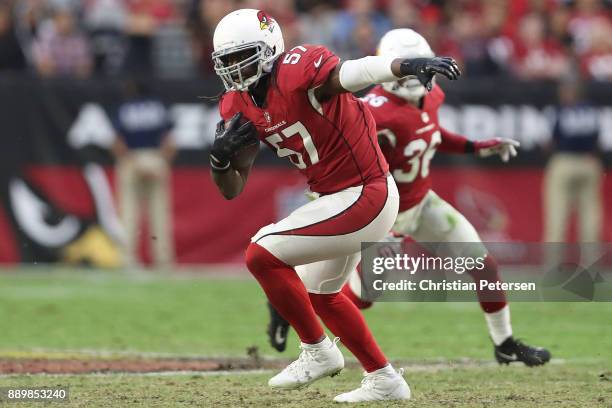 Josh Bynes of the Arizona Cardinals makes an interception against the Tennessee Titans in the second half at University of Phoenix Stadium on...