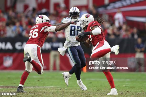 Delanie Walker of the Tennessee Titans watches as Josh Bynes of the Arizona Cardinals makes an interception in the second half at University of...