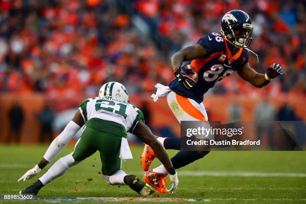 Wide receiver Demaryius Thomas of the Denver Broncos makes a catch under coverage by cornerback Morris Claiborne of the New York Jets in the fourth...