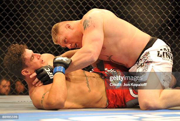 Brock Lesnar holds down Frank Mir during their heavyweight title bout during UFC 100 on July 11, 2009 in Las Vegas, Nevada.