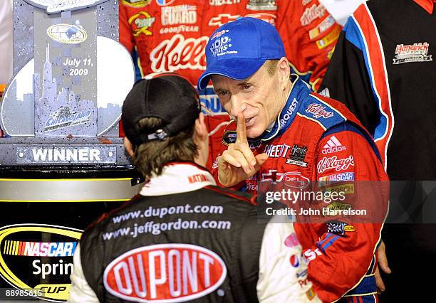 Mark Martin , driver of the CARQUEST/Kellogg's Chevrolet, is congratulated by by teammate Jeff Gordon, driver of the National Guard Patriot...