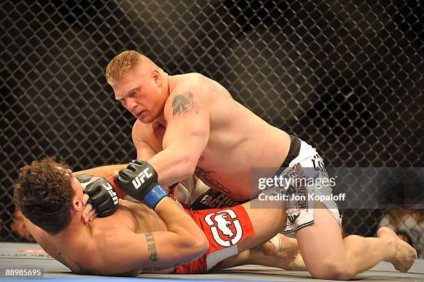 Brock Lesnar holds down Frank Mir during their heavyweight title bout during UFC 100 on July 11, 2009 in Las Vegas, Nevada. Lesnar defeated Mir by a...