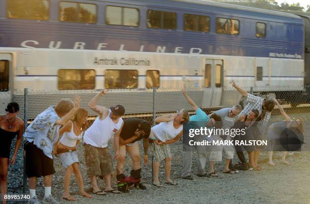 Residents of Laguna Niguel expose their buttocks during the 30th annual "Mooning of the trains" event along a stretch of railroad track in Orange...