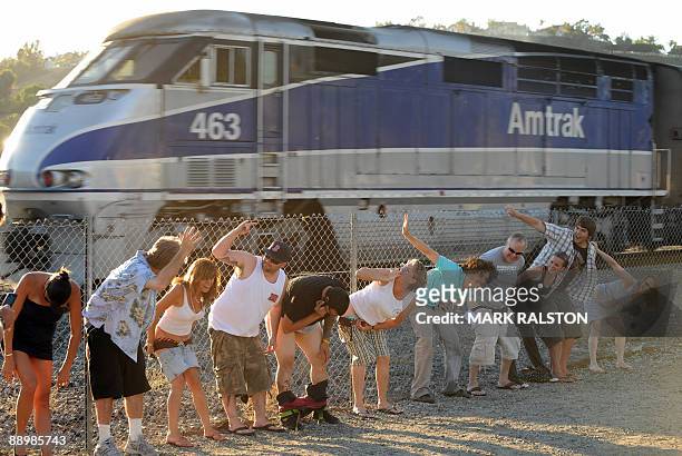Residents of Laguna Niguel expose their buttocks during the 30th annual "Mooning of the trains" event along a stretch of railroad track in Orange...