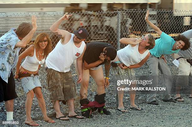 Residents of Laguna Niguel expose their buttocks during the 30th annual "Mooning of the trains" event along a stretch of railroad track in Orange...