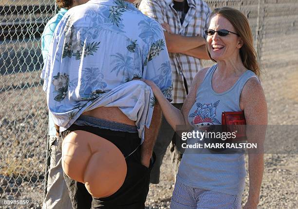 Woman laughs as residents of Laguna Niguel prepatre to expose their buttocks during the 30th annual "Mooning of the trains" event along a stretch of...