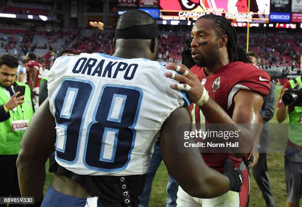 Brian Orakpo of the Tennessee Titans and Larry Fitzgerald of the Arizona Cardinals shake hands after the NFL game at University of Phoenix Stadium on...