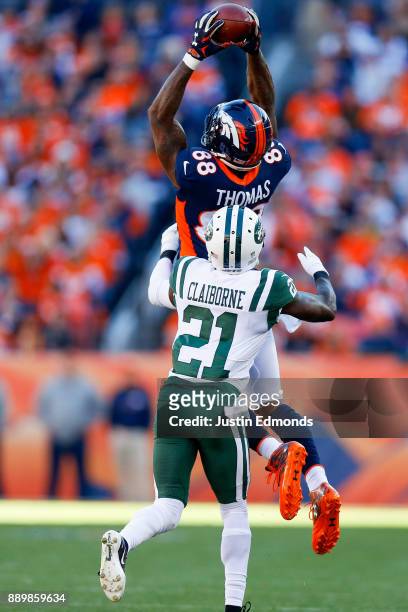 Wide receiver Demaryius Thomas of the Denver Broncos catches a pass while being defended by cornerback Morris Claiborne of the New York Jets during...