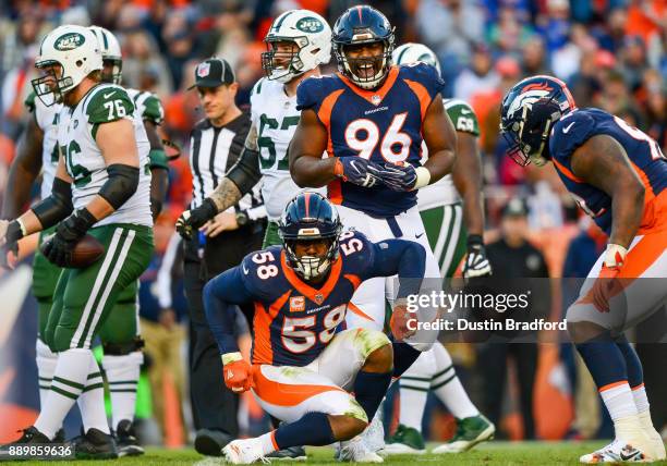 Outside linebacker Von Miller of the Denver Broncos celebrates along with Shelby Harris after a sack against the New York Jets in the third quarter...